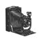 Hand drawn sketch of vintage camera in monochrome isolated on white background. Detailed woodcut style drawing.