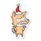 hand drawn sticker cartoon of a grinning fox wearing santa hat