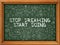 Hand Drawn Stop Dreaming Start Doing on Green Chalkboard.