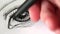 Hand draws in black pen a sketch of a female eye