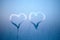 Hand drew heart on glass with drops of condensed steam with drops of water. Hot water vapor condenses on the cold glass in the