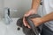 Hand drying with towel in a bathroom with white background