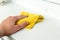 Hand dusting a window rag to reduce allergens in the home