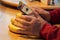 Hand of elderly man uses electronic device resting against bananas