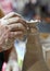 hand of an elderly potter while creating a clay pot on the rotat