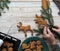 The hand of an elderly woman holds a Christmas cookie in the shape of a deer baked at home for the holiday.Preparatory work for