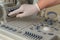 The hand of an elderly woman in a white medical glove presses the power button on the ultrasound machine.Closeup of the