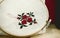 Hand embroidery cross-stitch flower ornament on a white fabric