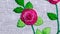 Hand embroidery flower close up, quality needlework on a white fabric