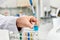 hand of an employee of a chemical laboratory dripping with a syringe blue drug