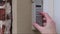 Hand entering code on keypad - garage door opener - home security