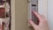 Hand entering code on keypad - garage door opener - home security