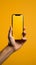 Hand extends box towards phone, against lively yellow backdrop intriguing convergence