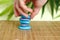 A hand that features pebbles in Zen lifestyle on a brown bamboo floor