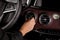 Hand of a female drive adjusting the air conditioning system  of a new SUV