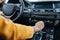 Hand of female driver shifting gear stick before driving car