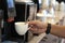 Hand of a female hotel staff at Automatic coffee service in the hotel for customer service