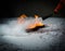 Hand of a firefighter putting out the fire on the snow