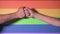 Hand fist with lgbt flag background. Lgbt pride concept. Gender equality concept. Pride flag with fist. Lgbt power concept