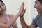 Hand of fitness man and woman giving each other high five after the training session in gym. Fit couple high five after