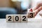 hand flipping block 2023 to 2024 text on table. Resolution, strategy, plan, goal, motivation, reboot, business and New Year