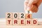 hand flipping block 2023 to 2024 TREND text on table. Resolution, idea, goal, motivation, reboot, business and New Year holiday