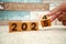 Hand flipping block 2024 to 2025 text on table