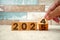 Hand flipping block 2024 to 2025 text on table