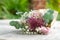 Hand flower bouquet consists of chrysanthemum, roses and green leaves