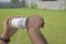 Hand flying kite holding thread on a grassland