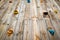 Hand and footholds on a wooden outdoor climbing wall