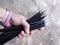 Hand full of hardly used black glass fibre archery crossbow bolts with field tips crop closeup