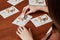 Hand of girl drawing with cigarette butts on postcard with lung cancer symbol