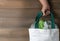 Hand girl holding canvas tote bag on wood