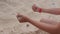 Hand of girl teenager making sand cake on summer beach close up