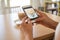 The hand of the girl using the phone to take coffee in the restaurant to post on social media