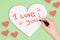 Hand girl writes lipstick love letter on Valentine`s Day. Handmade greeting card in the shape of a heart. Female kiss on