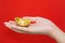 Hand giveing gold ingot for Chinese New Year celebration on red