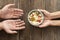 hand giving bowl food needy person. High quality photo