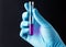Hand in a glove, holding test tube over