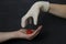 Hand without a glove holds dangerous red coronavirus, hand in white medical disposable rubber latex glove closes, destroys virus,