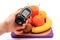 Hand with glucometer, fresh natural fruits, glass of juice