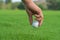 Hand Golfer hold Golf ball with tee ready to be shot at golf court