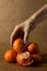 A hand grabbing from a pile of clementines on brown paper