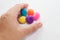 Hand grabing five colored balls