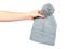 Hand with gray knitted hat, warm woolen accessory