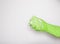 Hand in an green rubber glove with an green sponge and foam on a white background. Washing dishes, cleaning, home cleaning.