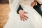 Hand of the groom gently embraces the bride\'s