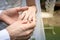 Hand of the groom wears a wedding ring bride