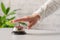 Hand of guest ringing in silver bell. reception desk with copy space. Hotel service. Selective focus.